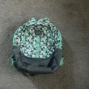 a teal grey and white back pack